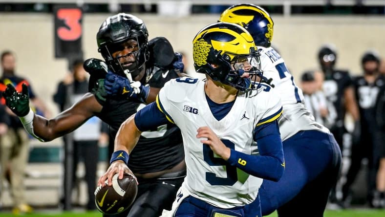 Michigan's J.J. McCarthy looks to throw against Michigan State during the first quarter on Saturday, Oct. 21, 2023, at Spartan Stadium in East Lansing.