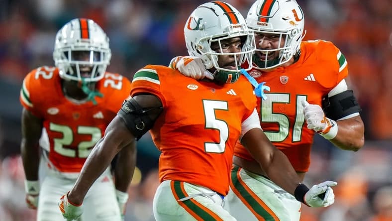 Oct 21, 2023; Miami Gardens, Florida, USA; Miami Hurricanes safety Kamren Kinchens (5) celebrates with teammates after catching a interception against the Clemson Tigers during the second quarter at Hard Rock Stadium. Mandatory Credit: Rich Storry-USA TODAY Sports