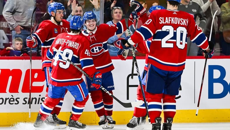 Oct 21, 2023; Montreal, Quebec, CAN; Montreal Canadiens right wing Cole Caufield (22) celebrates his winning goal against the Washington Capitals with his teammates during overtime at Bell Centre. Mandatory Credit: David Kirouac-USA TODAY Sports