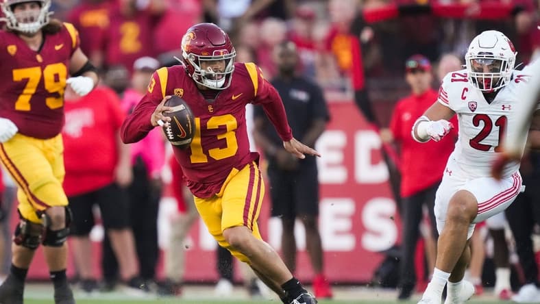 Oct 21, 2023; Los Angeles, California, USA; Southern California Trojans quarterback Caleb Williams (13) carries the ball against the Utah Utes in the first half at United Airlines Field at Los Angeles Memorial Coliseum. Mandatory Credit: Kirby Lee-USA TODAY Sports