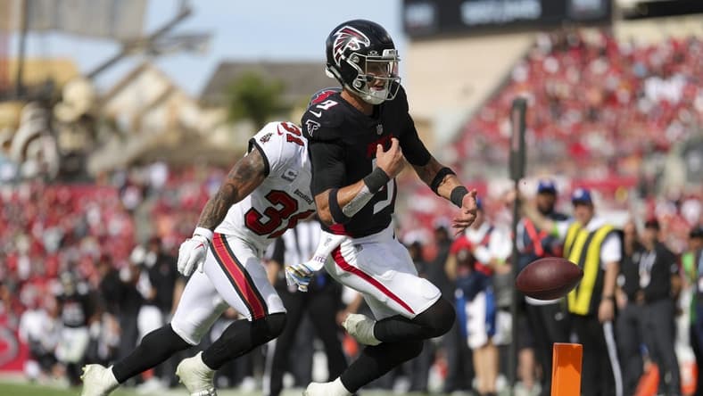 Oct 22, 2023; Tampa, Florida, USA; Tampa Bay Buccaneers safety Antoine Winfield Jr. (31) forces a fumble by Atlanta Falcons quarterback Desmond Ridder (9) at the goal line in the fourth quarter at Raymond James Stadium. Mandatory Credit: Nathan Ray Seebeck-USA TODAY Sports