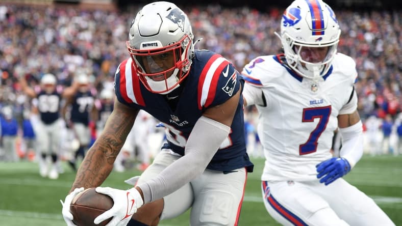 Oct 22, 2023; Foxborough, Massachusetts, USA; New England Patriots wide receiver Kendrick Bourne (84) scores a touchdown past Buffalo Bills cornerback Taron Johnson (7) during the second half at Gillette Stadium. Mandatory Credit: Bob DeChiara-USA TODAY Sports