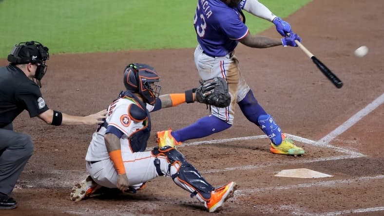 Oct 23, 2023; Houston, Texas, USA; Texas Rangers right fielder Adolis Garcia (53) hits a home run during the third inning of game seven in the ALCS against the Houston Astros for the 2023 MLB playoffs at Minute Maid Park. Mandatory Credit: Erik Williams-USA TODAY Sports