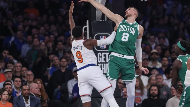 Oct 25, 2023; New York, New York, USA; Boston Celtics center Kristaps Porzingis (8) blocks a shot taken by New York Knicks guard RJ Barrett (9) in the first quarter at Madison Square Garden. Mandatory Credit: Wendell Cruz-USA TODAY Sports