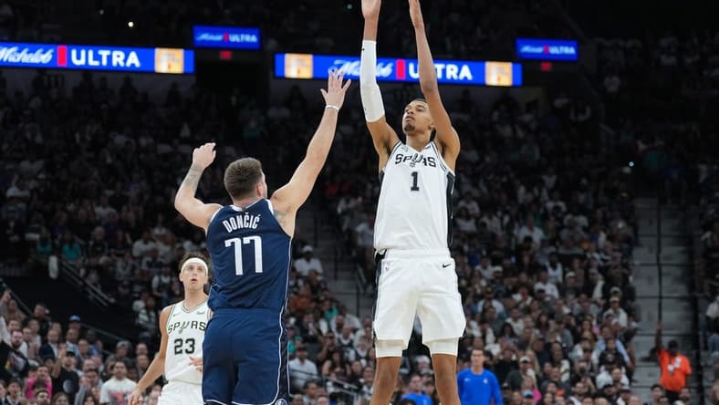 Oct 25, 2023; San Antonio, Texas, USA; San Antonio Spurs center Victor Wembanyama (1) shoots over Dallas Mavericks guard Luka Doncic (77) in the first half at the Frost Bank Center. Mandatory Credit: Daniel Dunn-USA TODAY Sports
