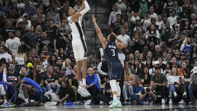 Oct 25, 2023; San Antonio, Texas, USA; San Antonio Spurs center Victor Wembanyama (1) shoots over Dallas Mavericks forward Grant Williams (3) in the second half at the Frost Bank Center. Mandatory Credit: Daniel Dunn-USA TODAY Sports