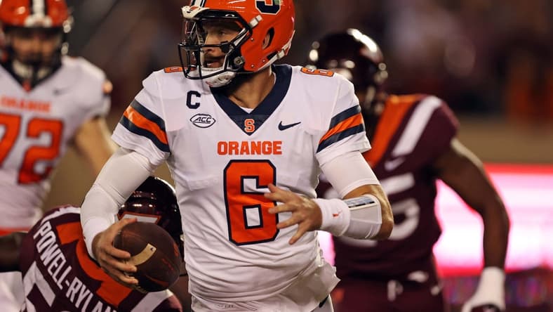 Oct 26, 2023; Blacksburg, Virginia, USA; Syracuse Orange quarterback Garrett Shrader (6) runs away from Virginia Tech Hokies defensive lineman Antwaun Powell-Ryland (52) during the first quarter at Lane Stadium. Mandatory Credit: Peter Casey-USA TODAY Sports