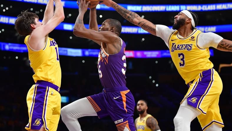 Oct 26, 2023; Los Angeles, California, USA; Phoenix Suns forward Kevin Durant (35) moves to the basket against Los Angeles Lakers guard Austin Reaves (15) and forward Anthony Davis (3) during the first half at Crypto.com Arena. Mandatory Credit: Gary A. Vasquez-USA TODAY Sports