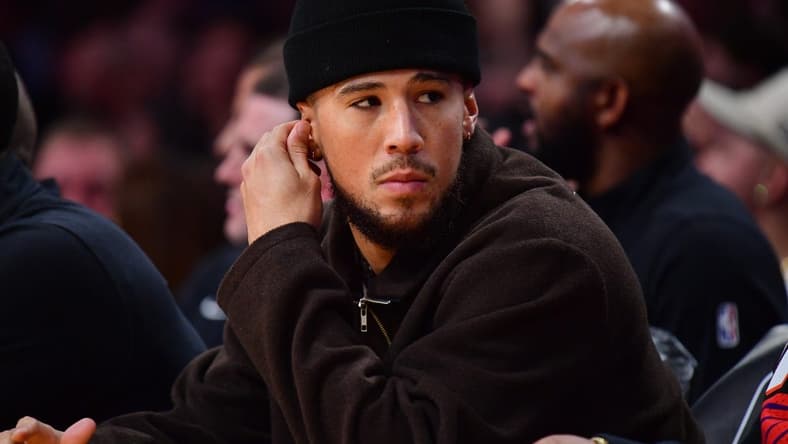 Oct 26, 2023; Los Angeles, California, USA; Phoenix Suns guard Devin Booker (1) watches game action against the Los Angeles Lakers during the first half at Crypto.com Arena. Mandatory Credit: Gary A. Vasquez-USA TODAY Sports