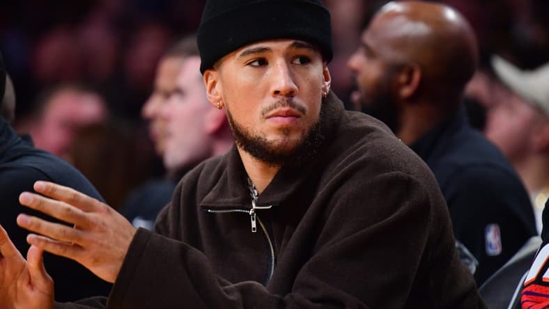 Oct 26, 2023; Los Angeles, California, USA; Phoenix Suns guard Devin Booker (1) watches game action against the Los Angeles Lakers during the first half at Crypto.com Arena. Mandatory Credit: Gary A. Vasquez-USA TODAY Sports