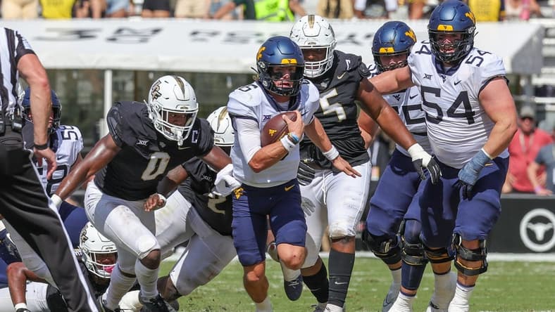 Oct 28, 2023; Orlando, Florida, USA; West Virginia Mountaineers quarterback Garrett Greene (6) carries the ball during the second quarter against the UCF Knights at FBC Mortgage Stadium. Mandatory Credit: Mike Watters-USA TODAY Sports