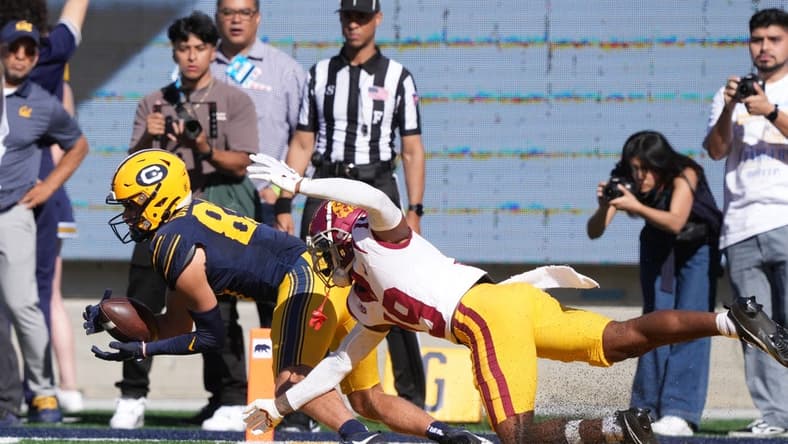 Oct 28, 2023; Berkeley, California, USA; California Golden Bears wide receiver Trond Grizzell (left) catches a touchdown pass against USC Trojans safety Jaylin Smith (right) during the second quarter at California Memorial Stadium. Mandatory Credit: Darren Yamashita-USA TODAY Sports