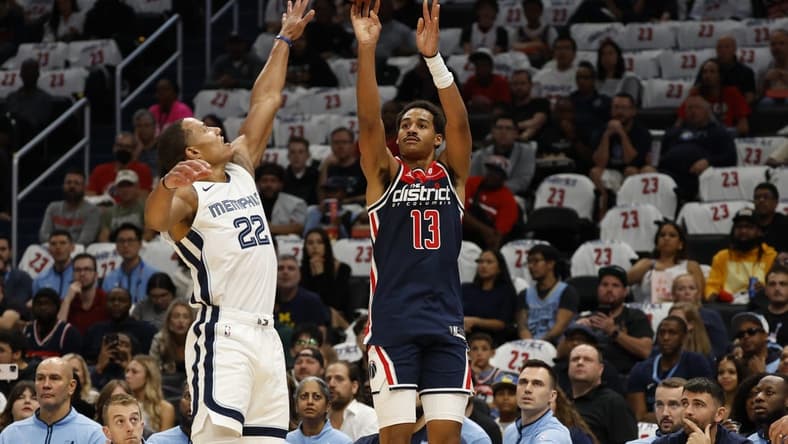 Oct 28, 2023; Washington, District of Columbia, USA; Washington Wizards guard Jordan Poole (13) shoots the ball over Memphis Grizzlies guard Desmond Bane (22) in the first quarter at Capital One Arena. Mandatory Credit: Geoff Burke-USA TODAY Sports