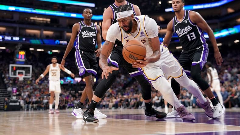 Oct 29, 2023; Sacramento, California, USA; Los Angeles Lakers forward Anthony Davis (3) falls to the ground after being fouled by Sacramento Kings forward Domantas Sabonis (10) in the second quarter at the Golden 1 Center. Mandatory Credit: Cary Edmondson-USA TODAY Sports