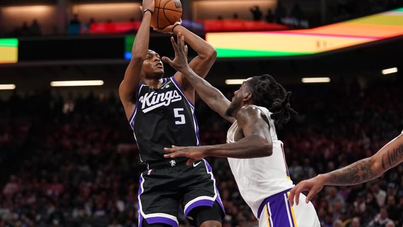 Oct 29, 2023; Sacramento, California, USA; Sacramento Kings guard De'Aaron Fox (5) shoots the ball over Los Angeles Lakers forward Taurean Prince (12) in the fourth quarter at the Golden 1 Center. Mandatory Credit: Cary Edmondson-USA TODAY Sports