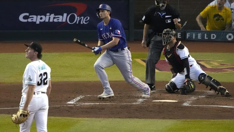 Oct 30, 2023; Phoenix, AZ, USA; Texas Rangers shortstop Corey Seager (5) hits a two-run home off Arizona Diamondbacks pitcher Brandon Pfaadt (32) during the third inning in game three of the 2023 World Series at Chase Field. Mandatory Credit: Rick Scuteri-USA TODAY Sports