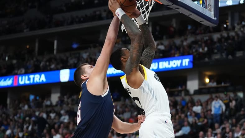 Oct 30, 2023; Denver, Colorado, USA; Denver Nuggets center Nikola Jokic (15) blocks the shot of Utah Jazz forward John Collins (20) in the second quarter at Ball Arena. Mandatory Credit: Ron Chenoy-USA TODAY Sports