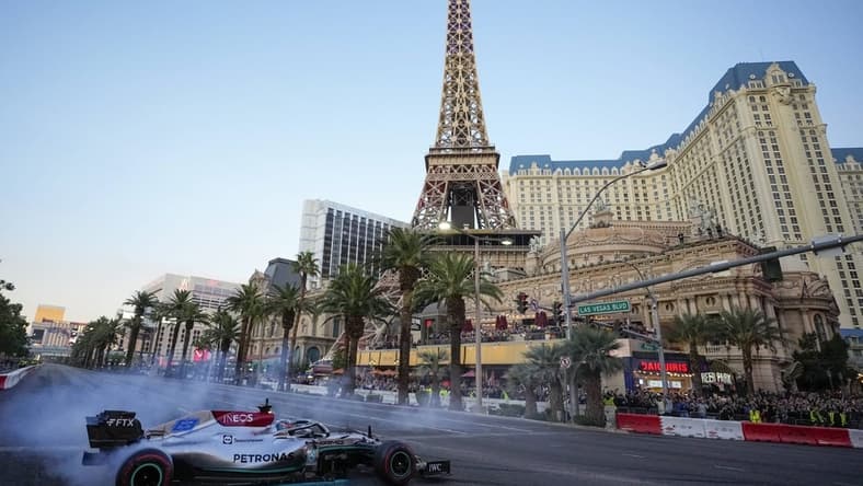 Nov 5, 2022; Las Vegas, Nevada, USA;  Mercedes-AMG Petronas driver George Russell spins his car on the track during the Formula One Las Vegas Grand Prix Launch Party at Las Vegas Strip. Mandatory Credit: Ray Acevedo-USA TODAY Sports