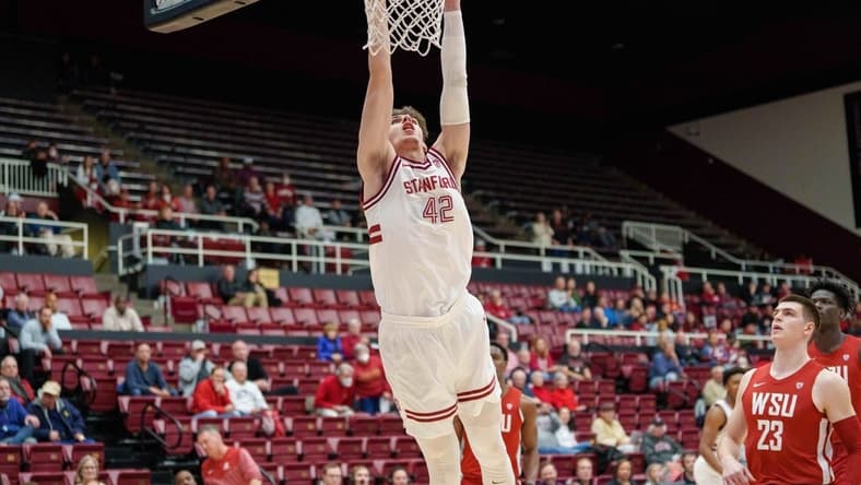 Feb 23, 2023; Stanford, California, USA;  Stanford Cardinal forward Maxime Raynaud (42) dunks the ball against Washington State Cougars forward Andrej Jakimovski (23) during the first half at Maples Pavilion. Mandatory Credit: Neville E. Guard-USA TODAY Sports