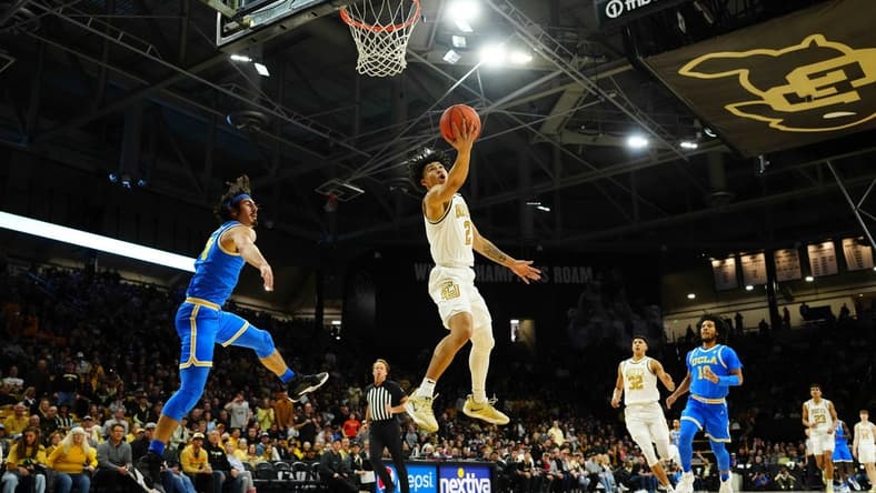 Feb 26, 2023; Boulder, Colorado, USA; Colorado Buffaloes guard KJ Simpson (2) shoots the ball past UCLA Bruins guard Jaime Jaquez Jr. (24) in the first half at the CU Events Center. Mandatory Credit: Ron Chenoy-USA TODAY Sports