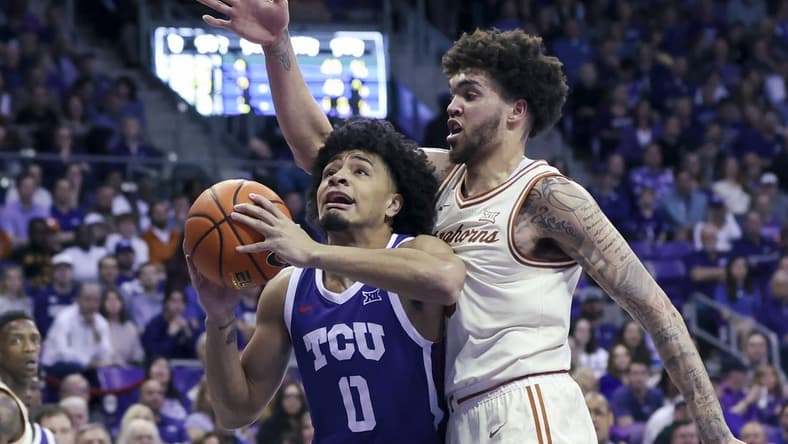 Mar 1, 2023; Fort Worth, Texas, USA;  TCU Horned Frogs guard Micah Peavy (0) shoots past Texas Longhorns forward Timmy Allen (0) during the first half at Ed and Rae Schollmaier Arena. Mandatory Credit: Kevin Jairaj-USA TODAY Sports