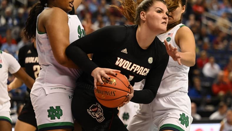 Mar 3, 2023; Greensboro, NC, USA; NC State Wolfpack center River Baldwin (1) controls the ball against Notre Dame Fighting Irish center Lauren Ebo (33) and forward Maddy Westbeld (21) during the first half at Greensboro Coliseum. Mandatory Credit: William Howard-USA TODAY Sports