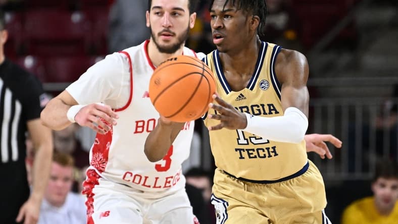 Mar 4, 2023; Chestnut Hill, Massachusetts, USA; Georgia Tech Yellow Jackets guard Miles Kelly (13) passes the ball past Boston College Eagles guard Jaeden Zackery (3) during the second half at the Conte Forum. Mandatory Credit: Brian Fluharty-USA TODAY Sports