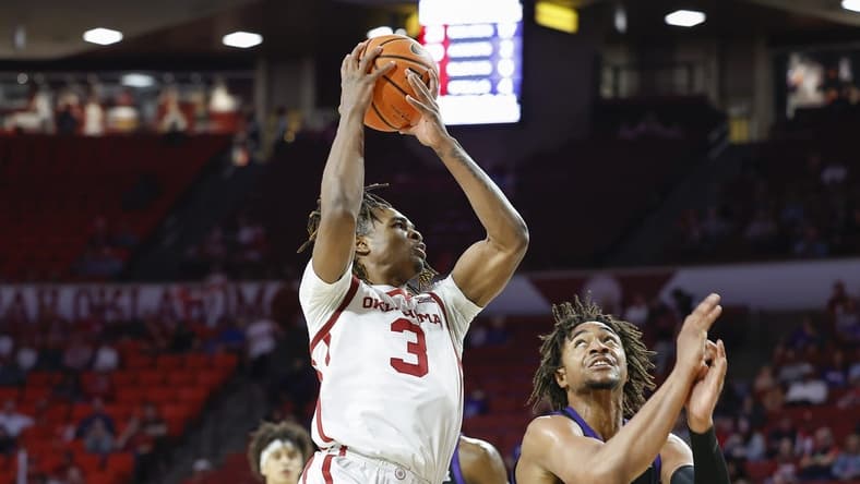 Mar 4, 2023; Norman, Oklahoma, USA; Oklahoma Sooners guard Otega Oweh (3) goes to the basket against TCU Horned Frogs forward Chuck O'Bannon Jr. (5) during the second half at Lloyd Noble Center. Oklahoma won 74-60. Mandatory Credit: Alonzo Adams-USA TODAY Sports
