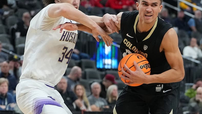 Mar 8, 2023; Las Vegas, NV, USA; Colorado Buffaloes forward Tristan da Silva (23) protects the ball from Washington Huskies center Braxton Meah (34) during the second half at T-Mobile Arena. Mandatory Credit: Stephen R. Sylvanie-USA TODAY Sports