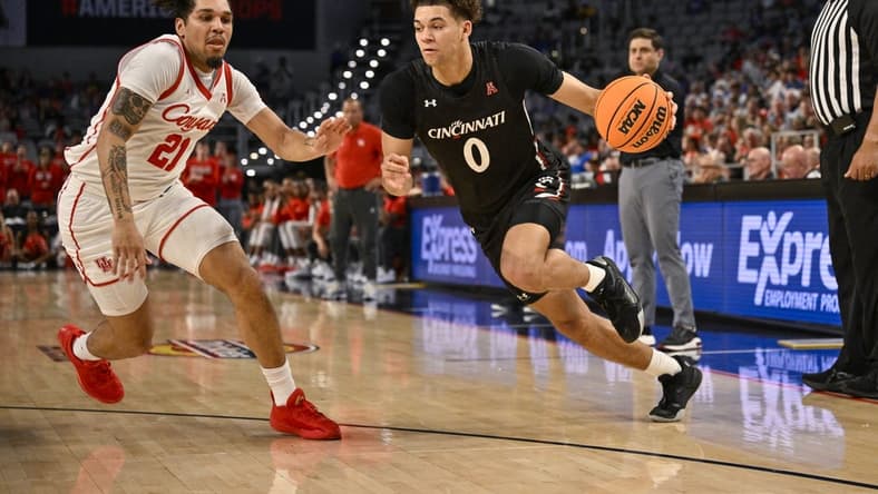 Mar 11, 2023; Fort Worth, TX, USA; Cincinnati Bearcats guard Dan Skillings Jr. (0) drives to the basket against Houston Cougars guard Emanuel Sharp (21) during the second half at Dickies Arena. Mandatory Credit: Jerome Miron-USA TODAY Sports