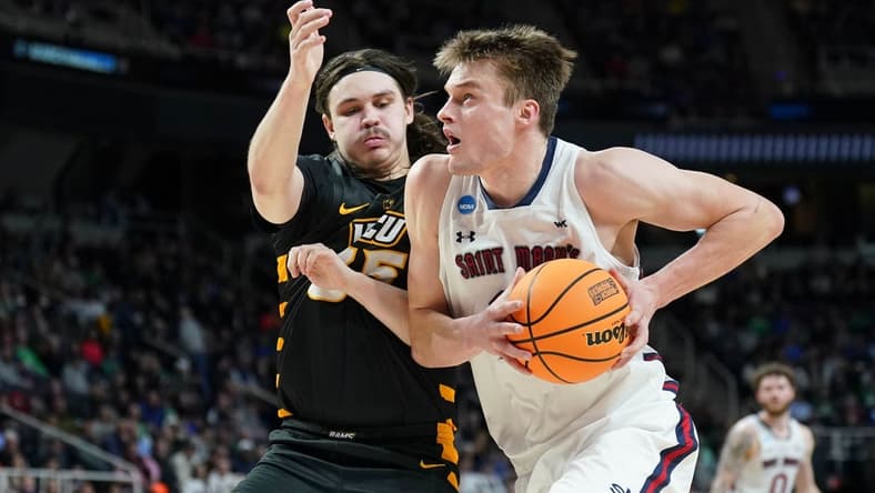 Mar 17, 2023; Albany, NY, USA; St. Mary's Gaels center Mitchell Saxen (11) dribbles the ball against Virginia Commonwealth Rams forward David Shriver (35) during the first half at MVP Arena. Mandatory Credit: David Butler II-USA TODAY Sports