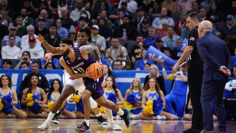 Mar 18, 2023; Sacramento, CA, USA; Northwestern Wildcats guard Boo Buie (0) looks for a pass while defended by UCLA Bruins guard Dylan Andrews (2) during the first half at Golden 1 Center. Mandatory Credit: Kelley L Cox-USA TODAY Sports