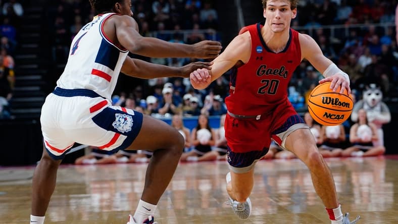 Mar 19, 2023; Albany, NY, USA; Saint Mary's Gaels guard Aidan Mahaney (20) dribbles the ball against Connecticut Huskies guard Nahiem Alleyne (4) during the second half at MVP Arena. Mandatory Credit: Gregory Fisher-USA TODAY Sports