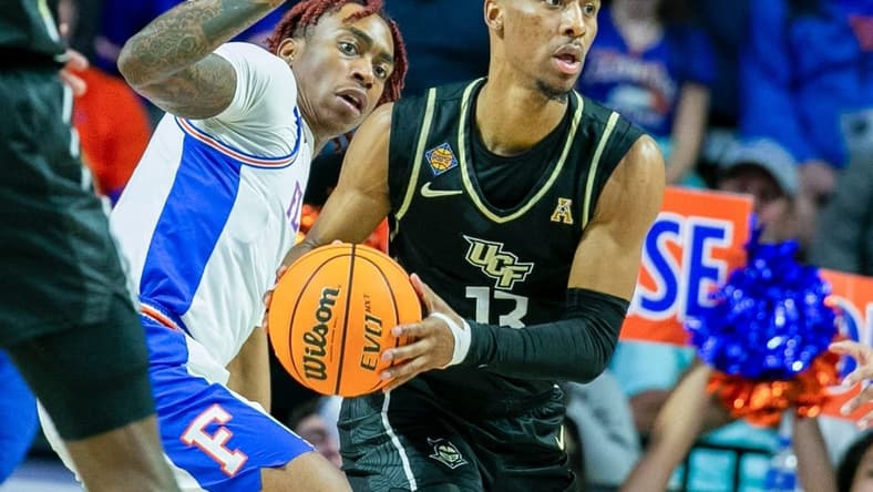 Florida Gators guard Niels Lane (4) tries to get the ball from UCF Knights guard C.J. Kelly (13) during the second half of the NIT tournament Wednesday, March 15, 2023, at Exactech Arena in Gainesville, Fla. Florida lost to UCF 67-49. Alan Youngblood/Gainesville Sun

Gai Ufucf3takeaways2 315753925416