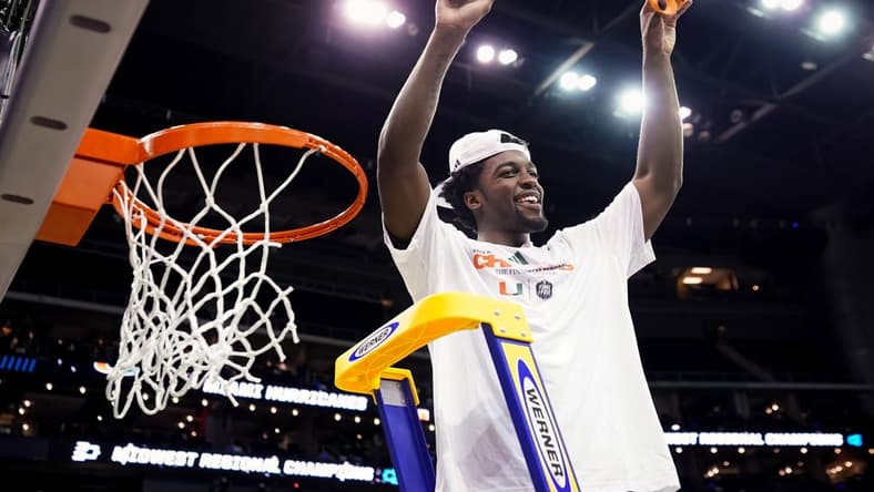 Mar 26, 2023; Kansas City, MO, USA; Miami (Fl) Hurricanes guard Bensley Joseph (4) cuts down the net after defeating the Texas Longhorns in an Elite 8 college basketball game in the Midwest Regional of the 2023 NCAA Tournament at T-Mobile Center. Mandatory Credit: Jay Biggerstaff-USA TODAY Sports