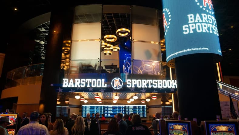 People line up in front of Barstool Sportsbook within Hollywood Casino at Kansas Speedway before the official start of legal sports betting on Sept. 1, 2022.