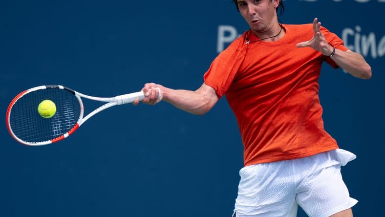 Alexander Shevchenko, of Russia, returns to Marton Fucsovics, of Hungary, during the Western & Southern Open qualifying round in Cincinnati on Saturday, Aug. 12, 2023.