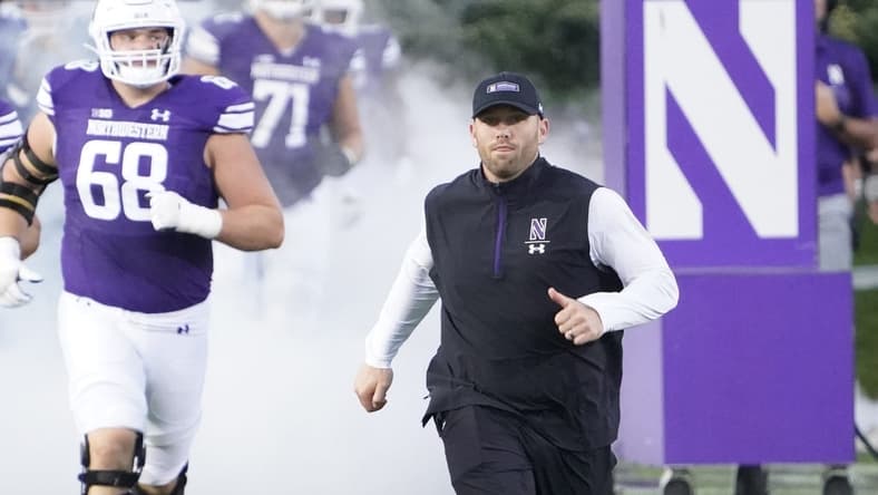 Sep 23, 2023; Evanston, Illinois, USA; Northwestern Wildcats head coach David Braun leads his team on the field before the game against the Minnesota Golden Gophers at Ryan Field. Mandatory Credit: David Banks-USA TODAY Sports