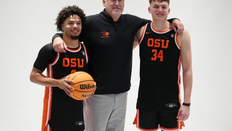 Oct 11, 2023; Las Vegas, NV, USA; Oregon State Beavers coach Wayne Tinkle (center) poses with guard Jordan Pope (0) and forward Tyler Bilodeau (34) during Pac-12 Media Day at Park MGM Las Vegas Conference Center. Mandatory Credit: Kirby Lee-USA TODAY Sports