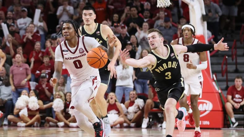 Oct 28, 2023; Fayetteville, AR, USA; Arkansas Razorbacks guard Khalif Battle (0) dribbles the ball against Purdue Boilermakers guard Braden Smith (3) on a fast break int he second half at Bud Walton Arena. Arkansas won 81-77. Mandatory Credit: Nelson Chenault-USA TODAY Sports