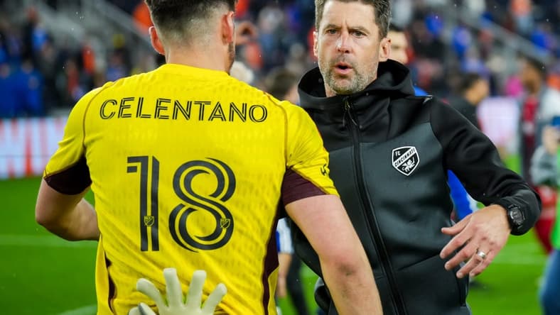 Oct 29, 2023; Cincinnati, OH, USA; FC Cincinnati head coach Pat Noonan hugs goalkeeper Roman Celentano (18) on the field after his team defeats the New York Red Bulls in game one in a round one match of the 2023 MLS Cup Playoffs at TQL Stadium. Mandatory Credit: Aaron Doster-USA TODAY Sports