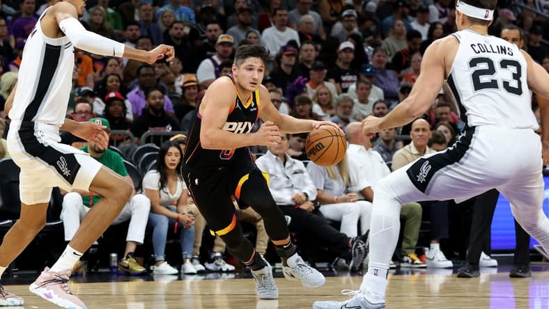 Oct 31, 2023; Phoenix, Arizona, USA; Phoenix Suns guard Grayson Allen #8 drives to the net agaisnt San Antonio Spurs center Victor Wembanyama #1 and forward Jeremy Sochan #10 during the second quarter at Footprint Center. Mandatory Credit: Zachary BonDurant-USA TODAY Sports