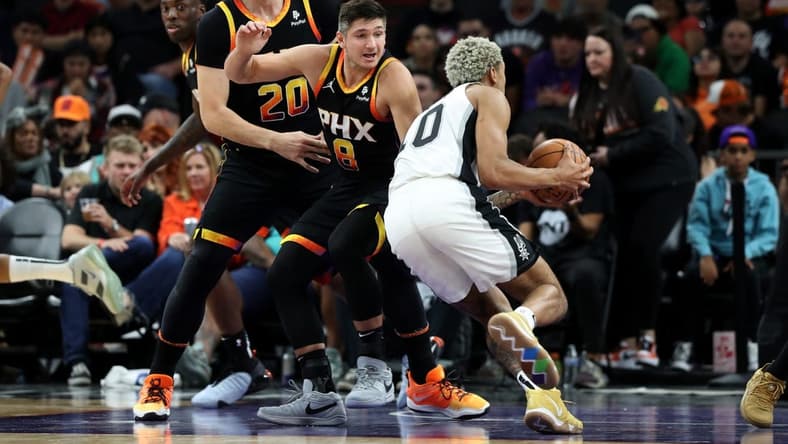 Oct 31, 2023; Phoenix, Arizona, USA; San Antonio Spurs forward Jeremy Sochan #10 drives to the net agaisnt Phoenix Suns guard Grayson Allen #8 and center Jusuf Nurkic #20 during the second half at Footprint Center. Mandatory Credit: Zachary BonDurant-USA TODAY Sports