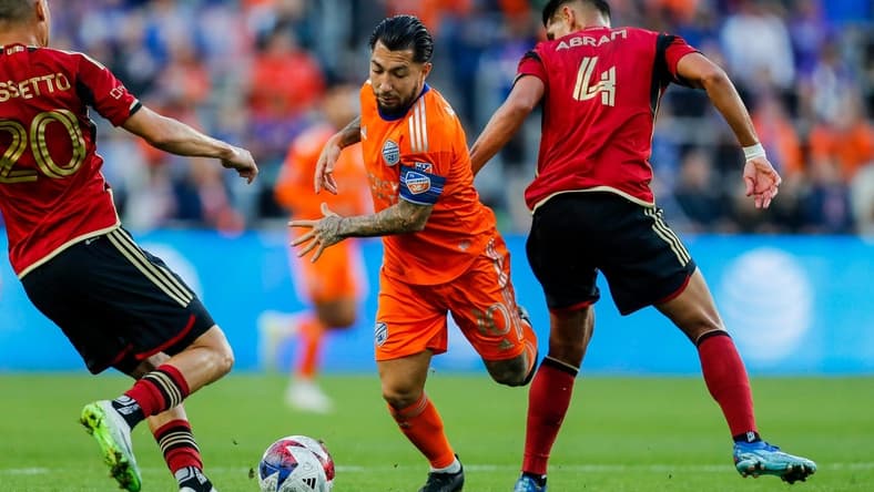 Oct 21, 2023; Cincinnati, Ohio, USA; FC Cincinnati midfielder Luciano Acosta (10) battles for the ball against Atlanta United FC midfielder Matheus Rossetto (20) and defender Luis Abram (4) in the first half at TQL Stadium. Mandatory Credit: Katie Stratman-USA TODAY Sports