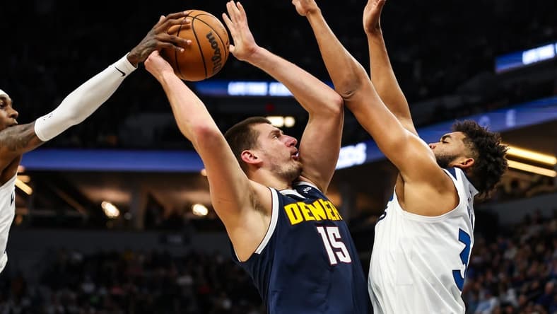 Nov 1, 2023; Minneapolis, Minnesota, USA; Minnesota Timberwolves forward Jaden McDaniels (3) blocks a shot by Denver Nuggets center Nikola Jokic (15) during the first half at Target Center. Mandatory Credit: Matt Krohn-USA TODAY Sports