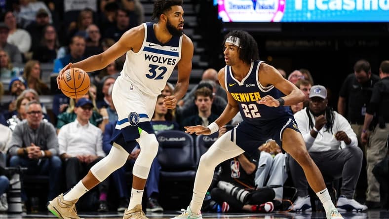 Nov 1, 2023; Minneapolis, Minnesota, USA; Minnesota Timberwolves center Karl-Anthony Towns (32) dribbles while Denver Nuggets forward Zeke Nnaji (22) defends during the first half at Target Center. Mandatory Credit: Matt Krohn-USA TODAY Sports