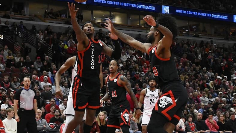 Nov 3, 2023; Chicago, Illinois, USA; Chicago Bulls forward Torrey Craig (13) and guard Coby White (0) chase a rebound against the Brooklyn Nets during the first half at the United Center. Mandatory Credit: Matt Marton-USA TODAY Sports