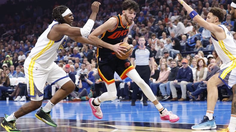 Nov 3, 2023; Oklahoma City, Oklahoma, USA; Oklahoma City Thunder forward Chet Holmgren (7) drives between Golden State Warriors forward Kevon Looney (5) and guard Klay Thompson (11) during the second quarter at Paycom Center. Mandatory Credit: Alonzo Adams-USA TODAY Sports
