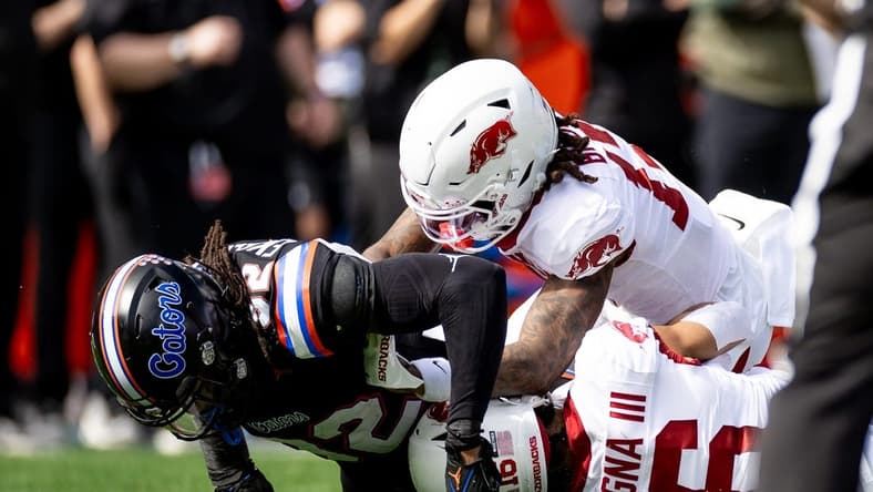 Florida Gators safety Cahron Rackley (32) tackles Arkansas Razorbacks wide receiver Isaiah Sategna (16) during a kickoff during the first half at Steve Spurrier Field at Ben Hill Griffin Stadium in Gainesville, FL on Saturday, November 4, 2023. [Matt Pendleton/Gainesville Sun]