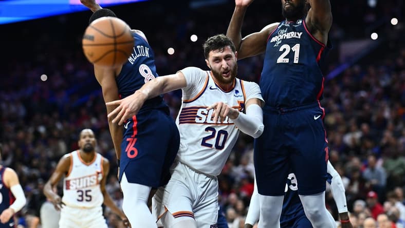 Nov 4, 2023; Philadelphia, Pennsylvania, USA; Phoenix Suns center Jusuf Nurkic (20) passes the ball between Philadelphia 76ers center Joel Embiid (21) and guard De'Anthony Melton (8) in the first quarter at Wells Fargo Center. Mandatory Credit: Kyle Ross-USA TODAY Sports